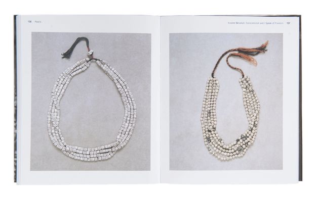 Pages of a book. An illustration on each page shows necklaces made of strips of paper coiled into beads and strung.